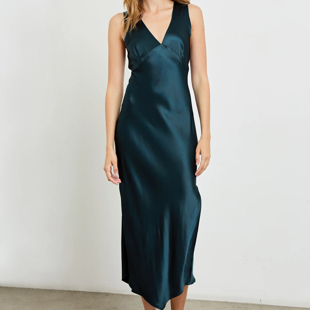 A woman wearing the Monique Midi Slip Dress in the color Deep Sea by the brand Rails