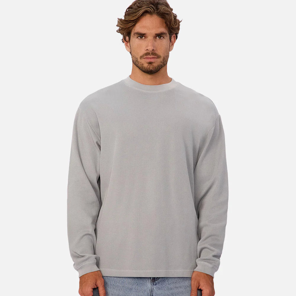 A man wearing a grey long sleeve shirt from Industrie