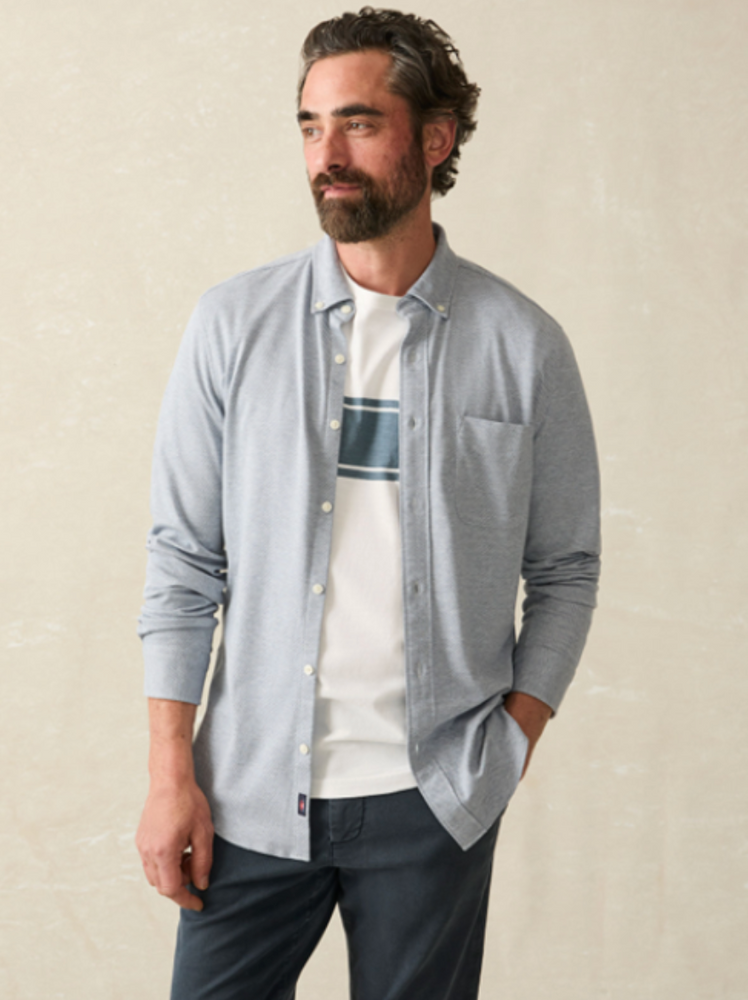 Fron view of a man wearing the Oceanside Blue Coastline Knit Shirt by Faherty