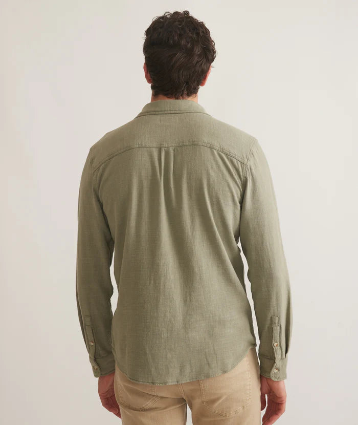 Back view of men's casual long sleeve button down shirt in light olive green color