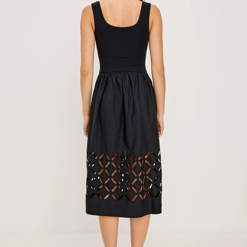 
                      
                        A woman wearing a black dress with cut-out design
                      
                    