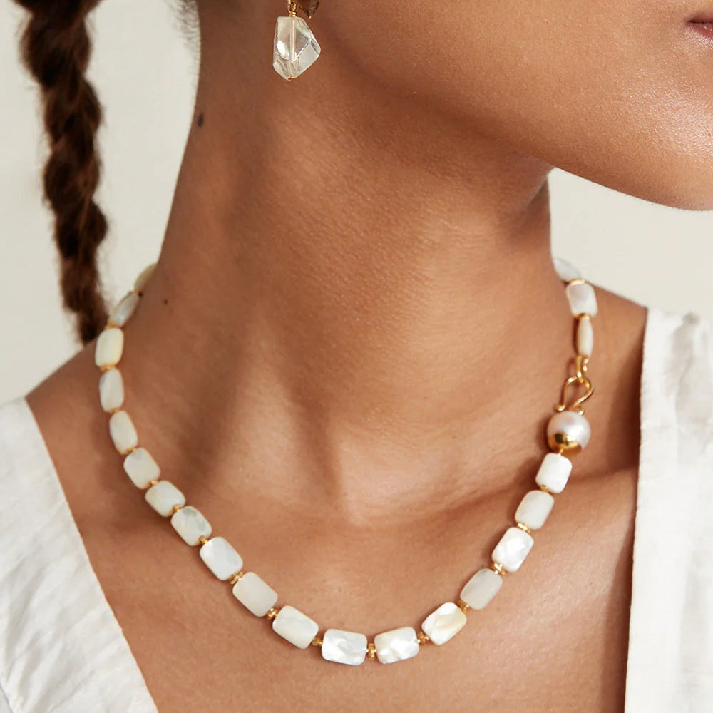 
                      
                        Woman wearing the White Mother of Pearl Luz Necklace by Chan Luu
                      
                    