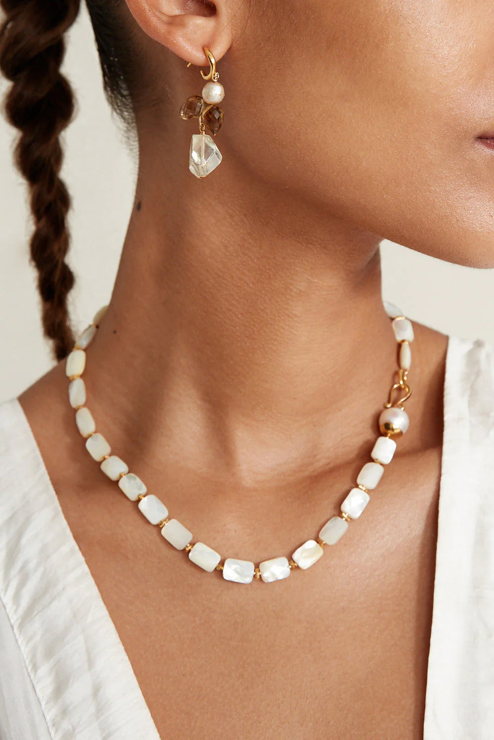 Woman wearing the White Mother of Pearl Luz Necklace by Chan Luu