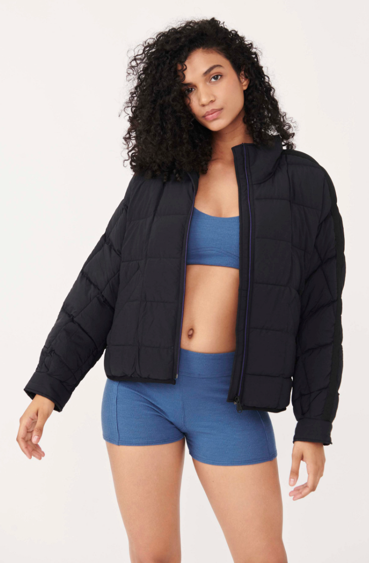 Front view of a woman wearing the Pippa Packable Black Puffer Jacket by Free People