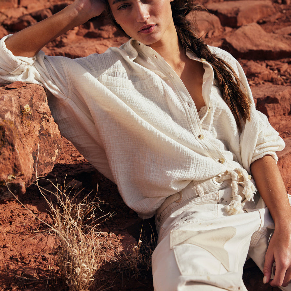 Woman wearing Free People's Optic White Cardiff Button Down Top