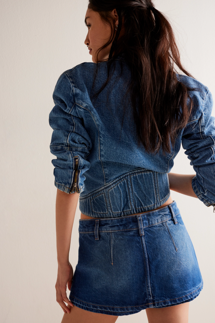 A woman wearing a medium blue denim skort and jacket from From People