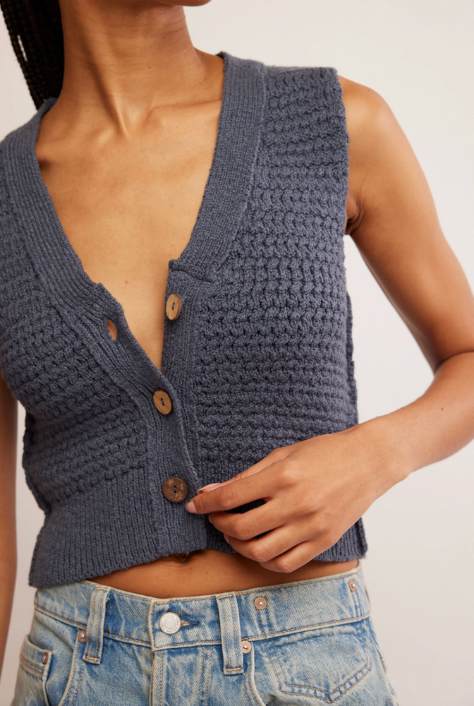 
                      
                        Women's knit vest with front button closure. 
                      
                    