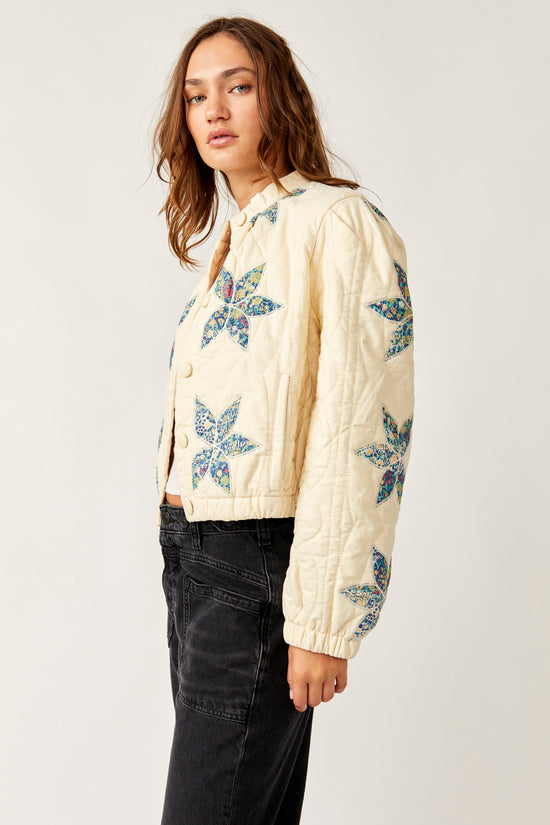 Side view of the Free People Quinn Quilted Jacket in the color Teal Combo