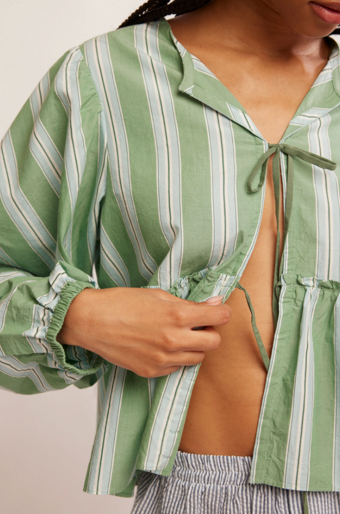 
                      
                        Women's shapeless, green and white striped blouse with front tie closure and ruffle details. 
                      
                    