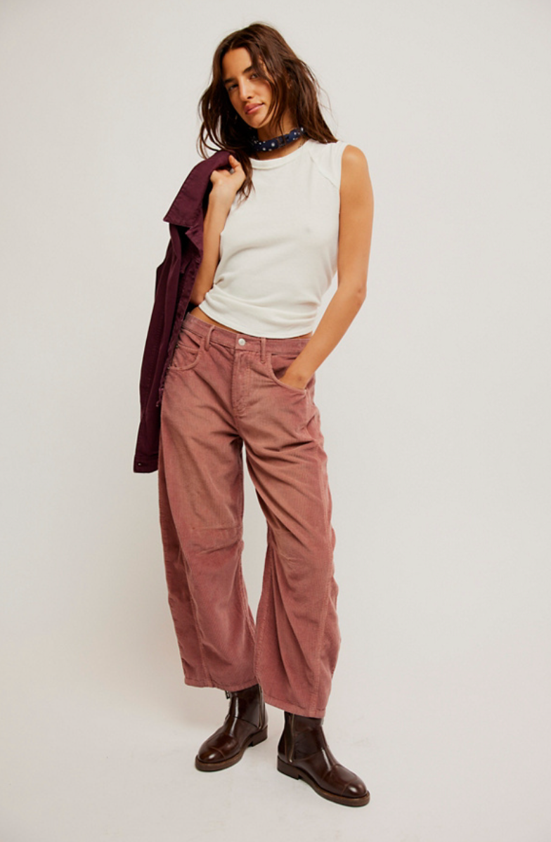 These pink cord barrel jeans from Free People offer belt loops at the waistband and 4-pocket styling