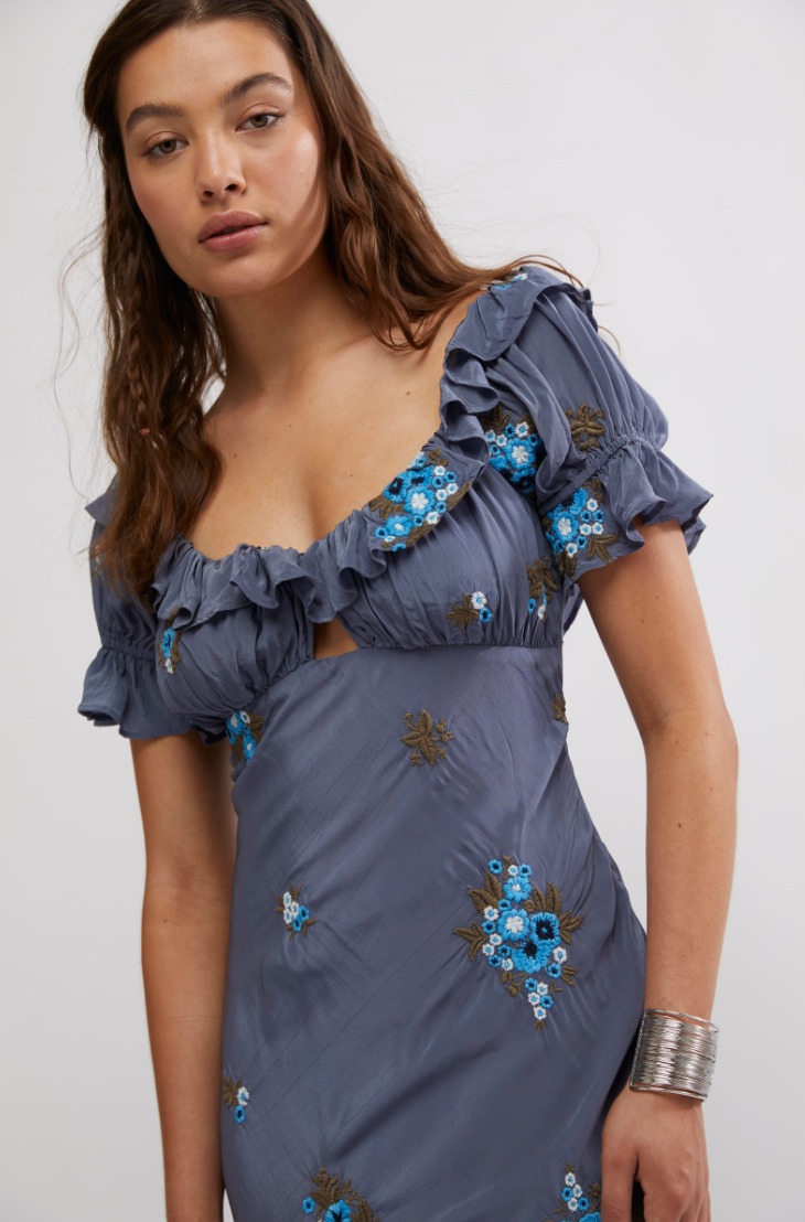 Women's floral embroidered maxi dress with short puff sleeves and ruched bust. 