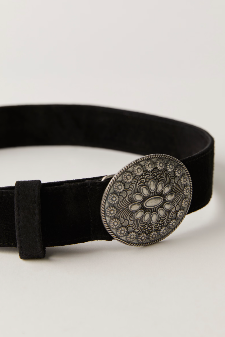 Black belt with a decorative silver buckle on a light gray background