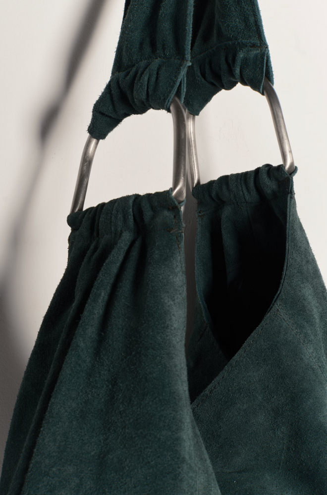 
                      
                        Dark green tote bag with metal details
                      
                    