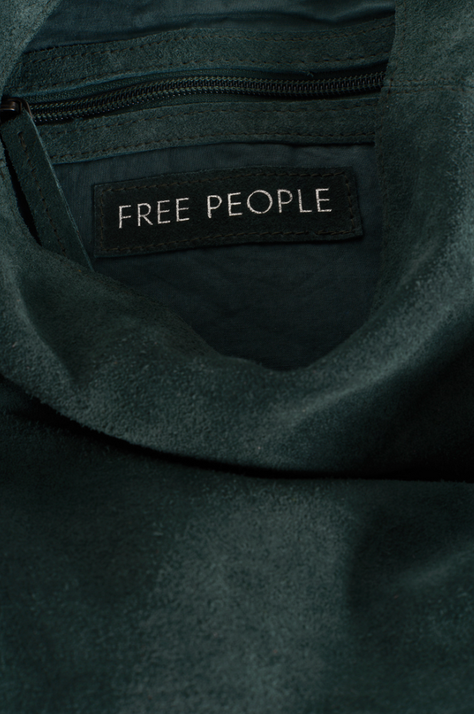 
                      
                        Dark green tote bag with 'Free People' label
                      
                    