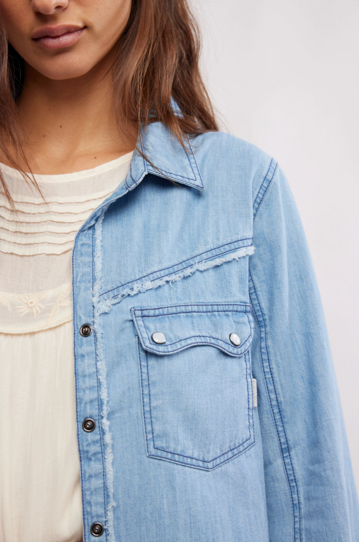 Women's western-style denim shirt with raw seaming detail and patch pockets at the chest