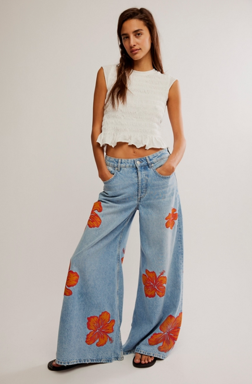 Stand out from the crowd when you wear these cool and casual wide leg floral print jeans from Free People, available now at Harbour Thread Burlington. 