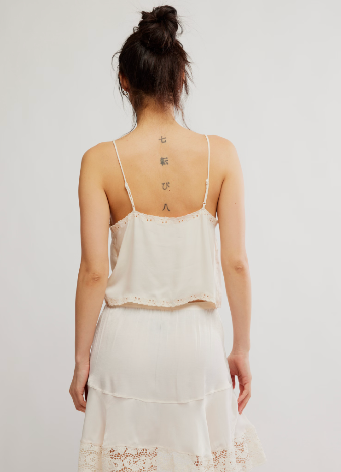 
                      
                        Person wearing a white Free People cami
                      
                    
