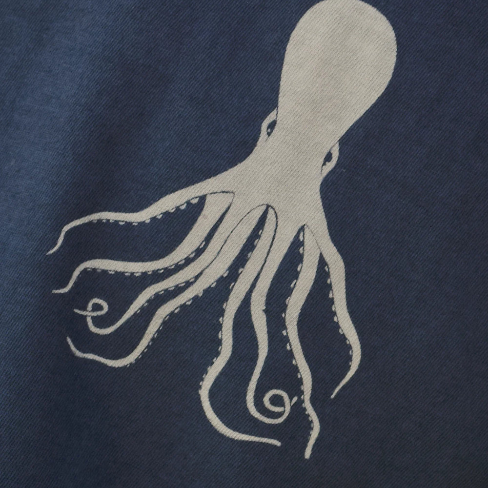 
                      
                        Close up view of the white octopus graphic against the navy color of the shirt
                      
                    