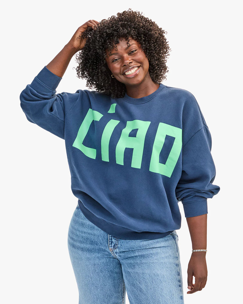 This navy Oversized Sweatshirt from Clare V. features large mint colored font that says 