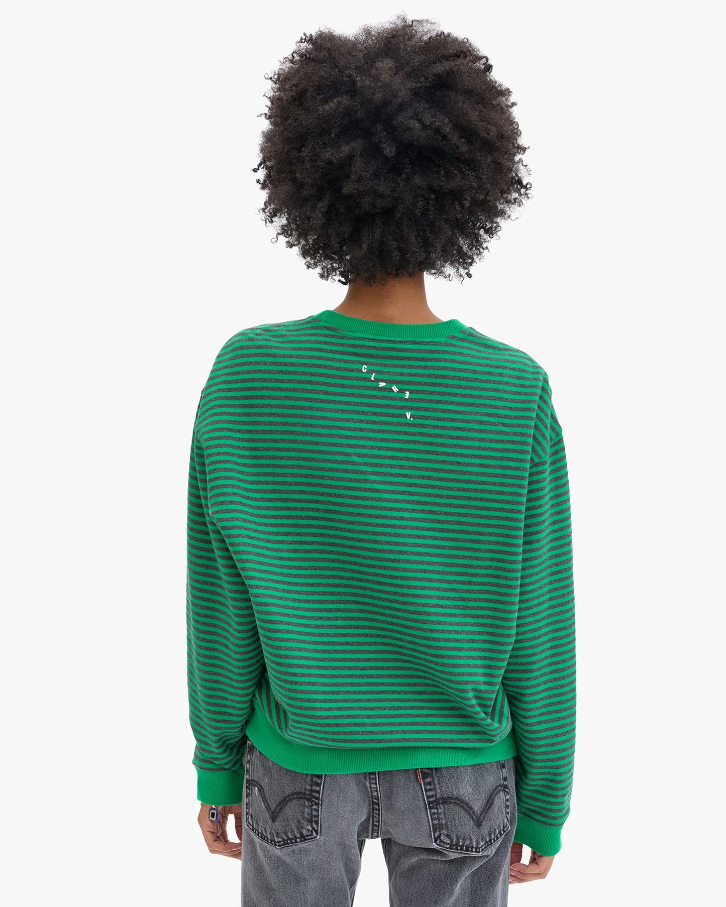 Person wearing a green striped sweater from Clare V. 