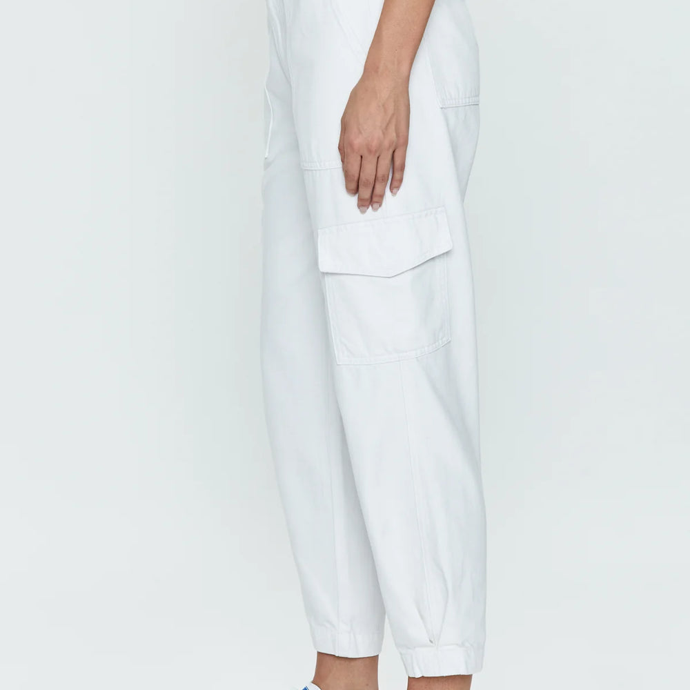 
                      
                        Side view of woman wearing sleek white cargo pants with a high rise and tapered ankle hem
                      
                    