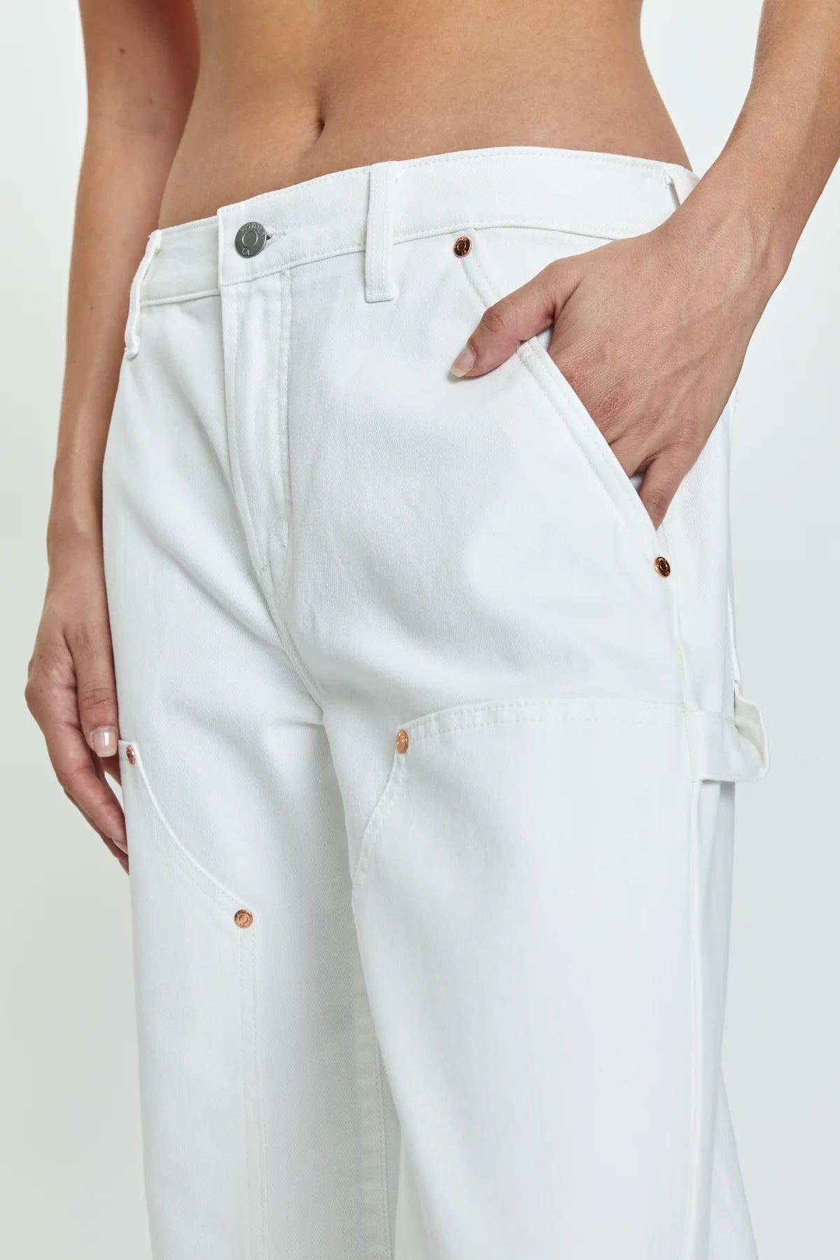 Side detail view of PISTOLA's Lexi Mid Rise Carpenter Jeans in the color White