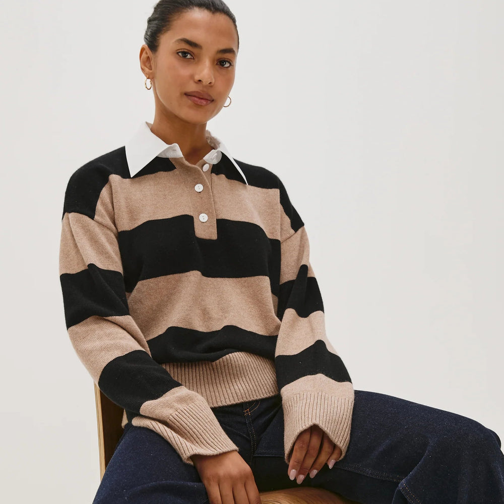 A woman sitting down while wearing the Paxton Sweater from Rails