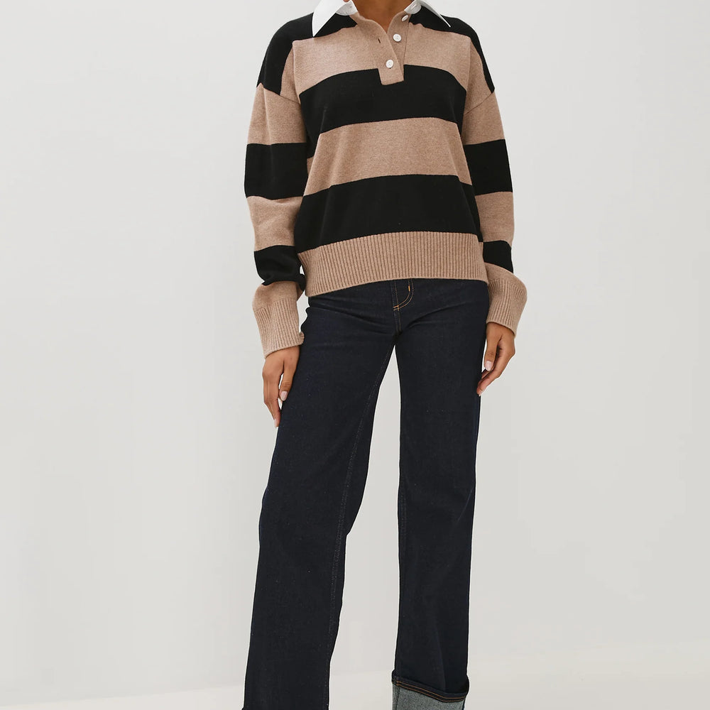 
                      
                        Person wearing a striped sweater and black pants
                      
                    