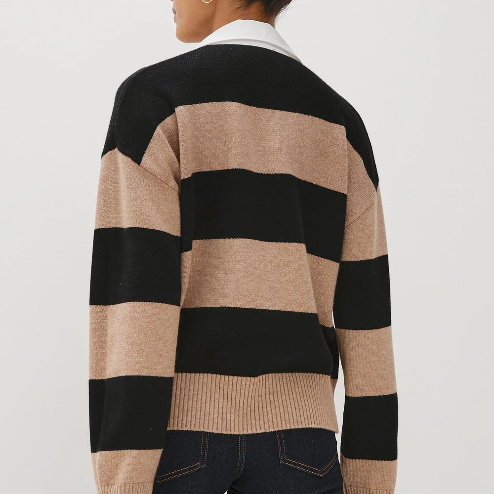 
                      
                        A woman wearing a black and beige striped sweater from Rails
                      
                    