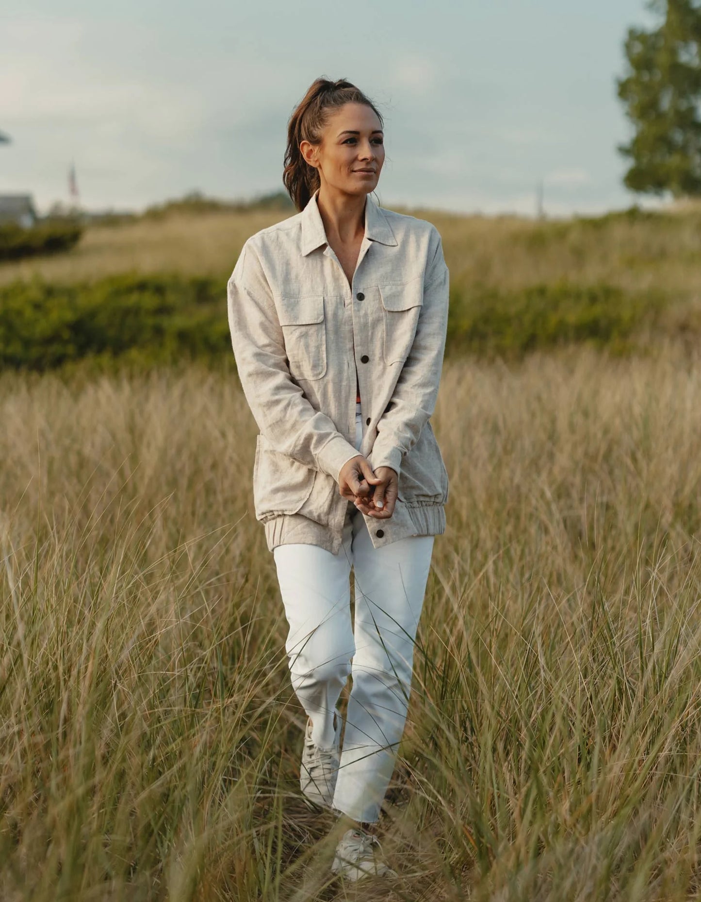 Woman in a field wearing The Normal Brand's Oversized Camp Shacket