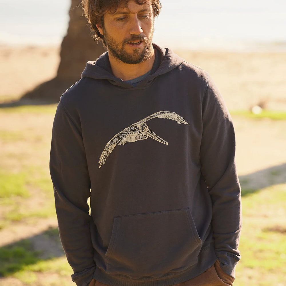 
                      
                        Front view of man wearing a faded navy hooded pullover with a pelican graphic on the front
                      
                    