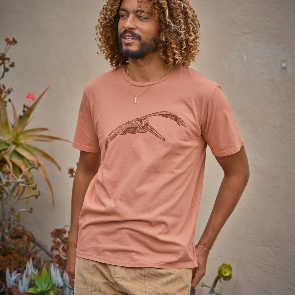 men's light red short sleeve t-shirt featuring a pelican on the front