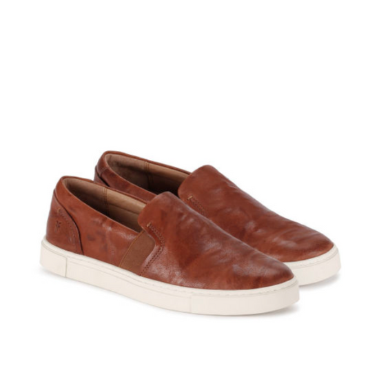 A pair of cognac leather slip on sneakers by Frye