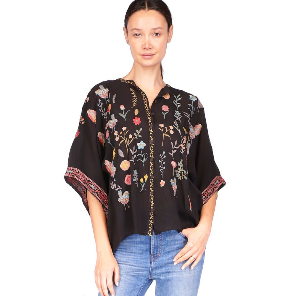 Front view of woman wearing the black, embroidered Roylane Blouse by Johnny Was