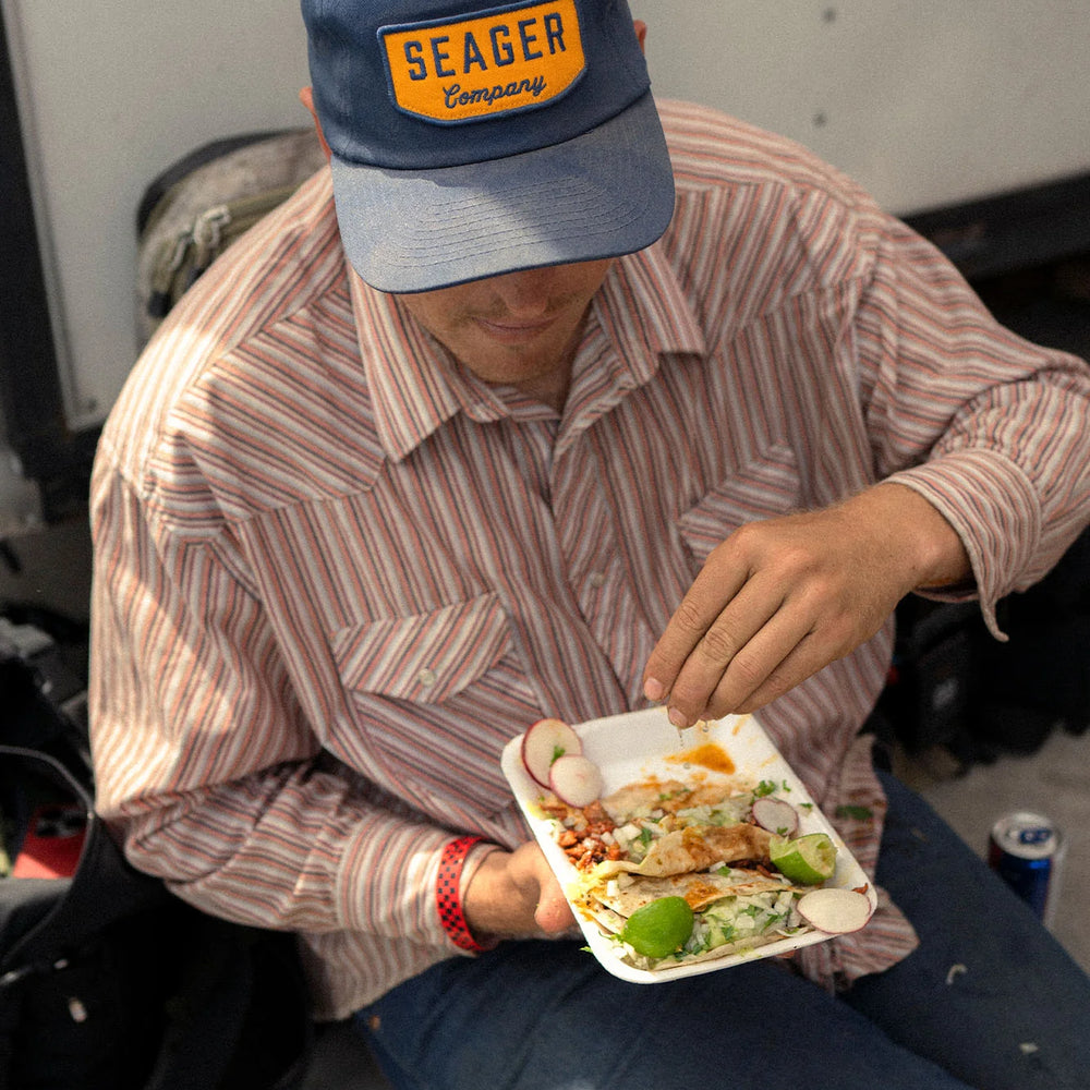 Man wearing Seager's Navy and Yellow Wilson Snapback Hat