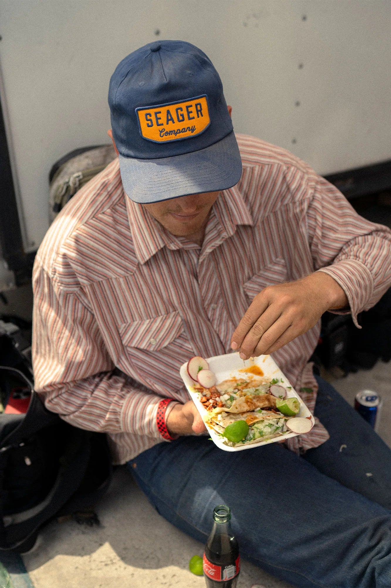 Man wearing Seager's Navy and Yellow Wilson Snapback Hat