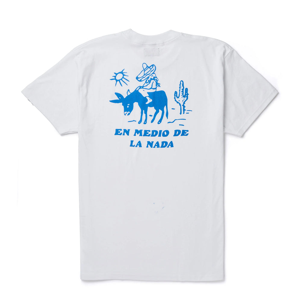 
                      
                        Back view of the white short sleeve Nowhere Tee from Seager, featuring a back graphic with "en medio de la nada" printed under a man in a sombrero riding a donky in the desert. 
                      
                    