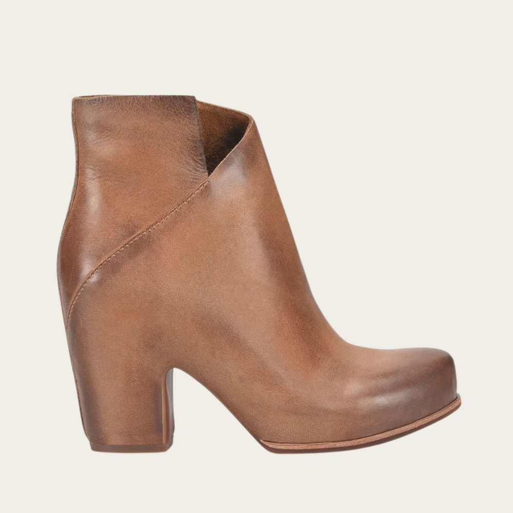 
                      
                        The brown leather Seeley hidden platform bootie by Kork-Ease features a unique cross-front silhouette
                      
                    