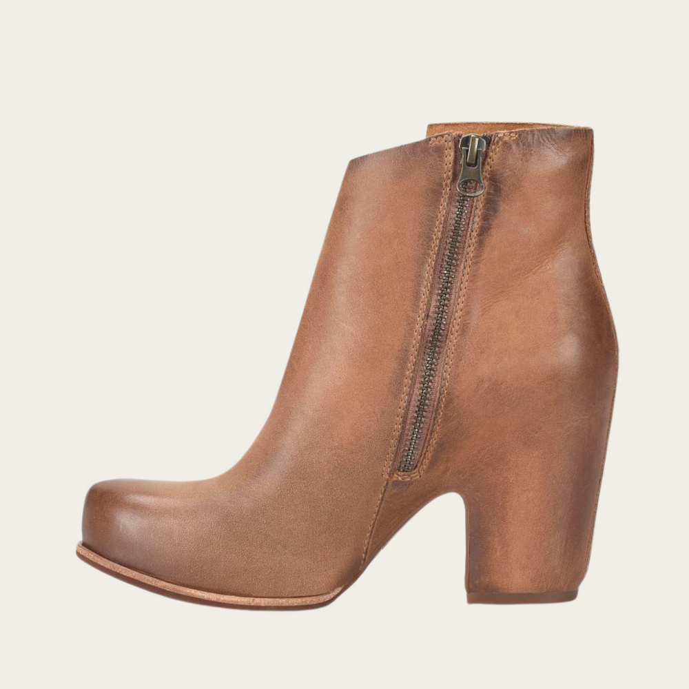 
                      
                        The brown leather Seeley hidden platform bootie by Kork-Ease offers an interior zip closure for easy on and off
                      
                    