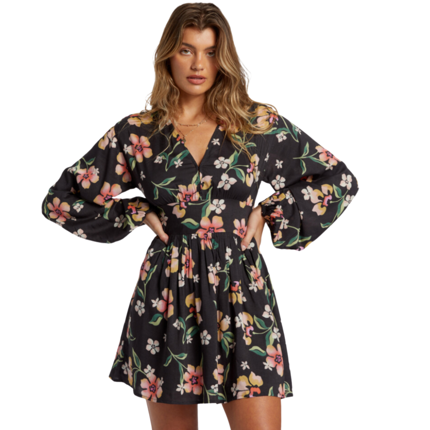 A woman wearing the long sleeve Night Bloom Mini Dress from Billabong in the color Black Sands