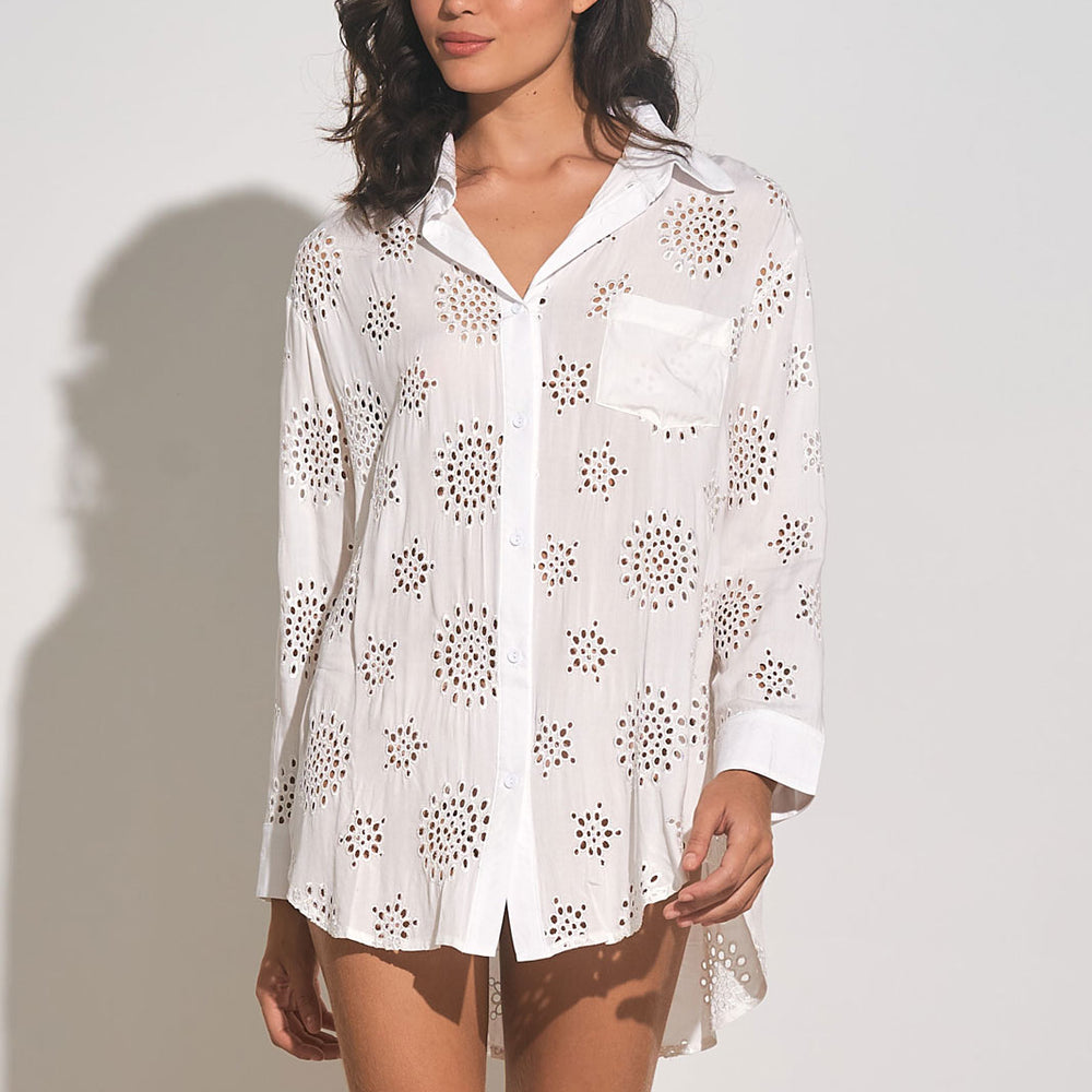 
                      
                        Front view of woman wearing a white long sleeve button down cover up shirt with eyelet embroidery throughout
                      
                    