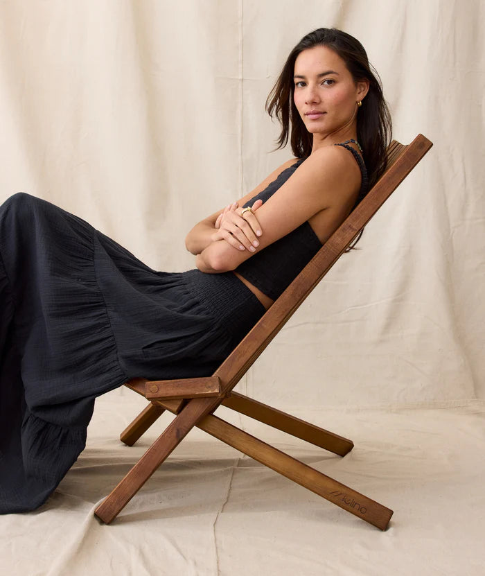 A woman wearing the Marine Layer Corinne Double Cloth Maxi Skirt in Jet Black