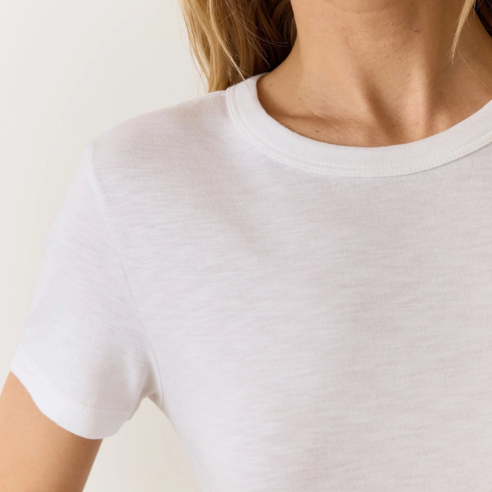 Woman wearing a white short sleeve crewneck tee