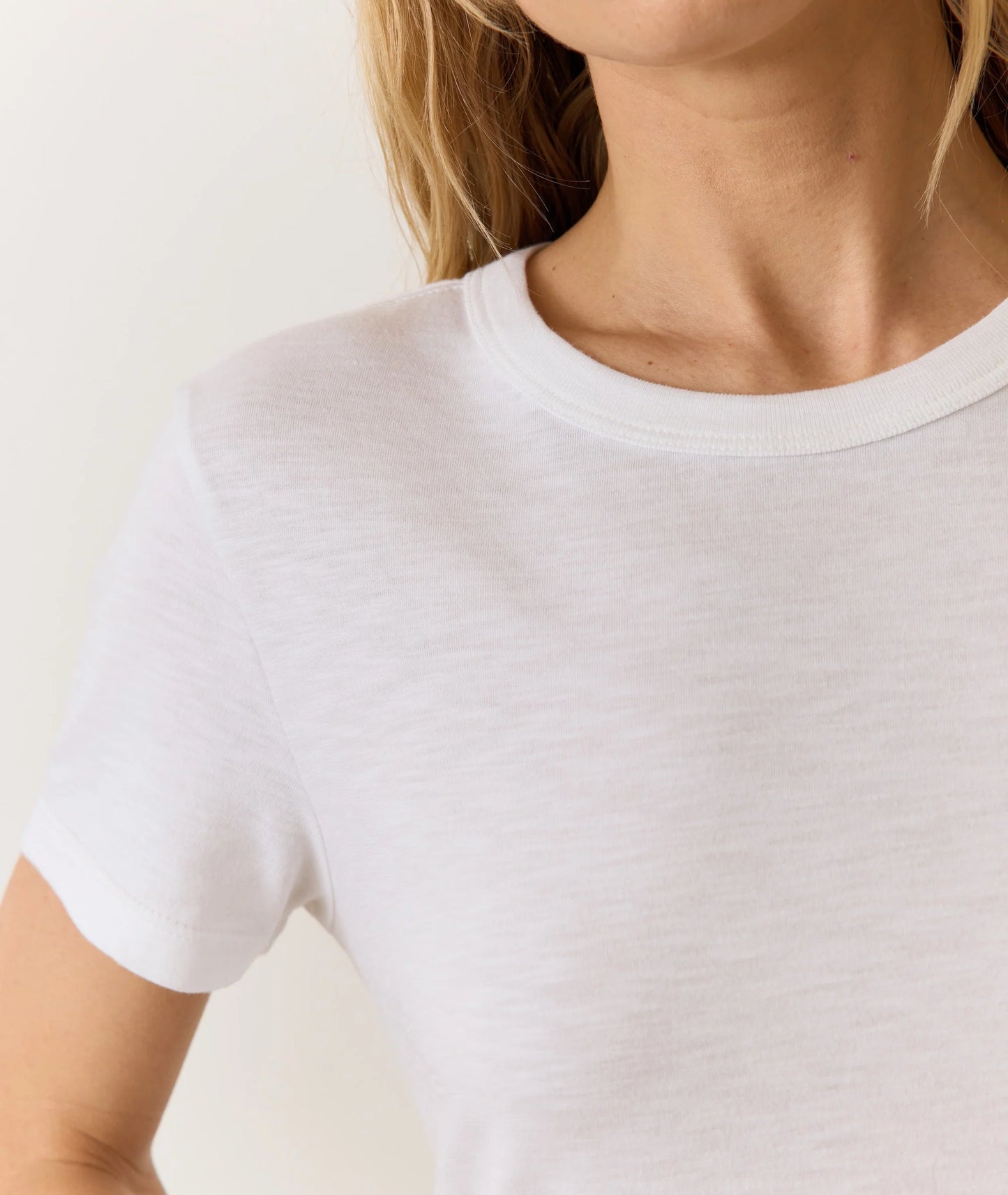 Woman wearing a white short sleeve crewneck tee