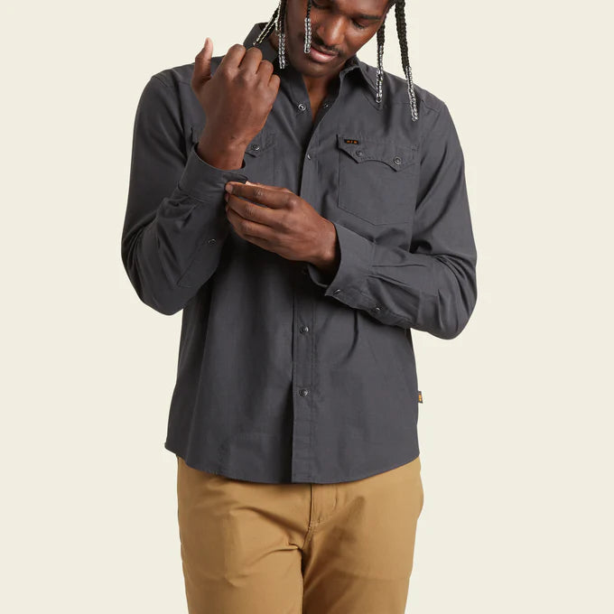 Front view of man wearing a dark grey, western-style snap button up shirt