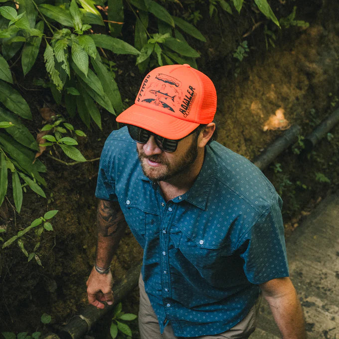 Man wearing the Howler Bros Astrol Order Foam Dome Hat in Orange