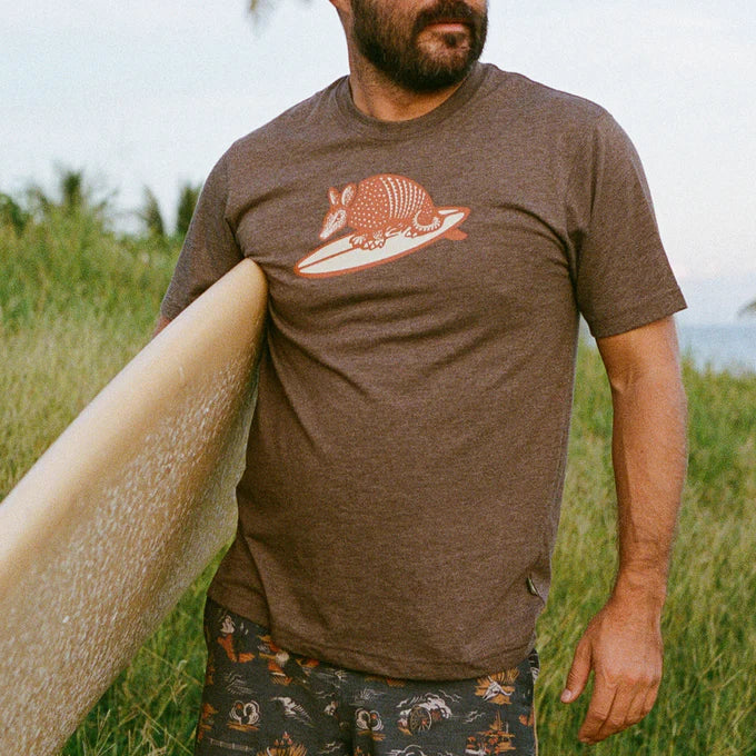 Outdoor lifestyle Front view of man wearing a brown short sleeve t-shirt with an armadillo graphic on the front