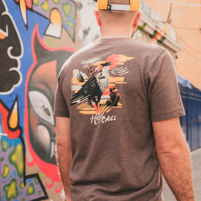 Back view of man wearing the brown short sleeve Caracara men's t-shirt by Howler Bros