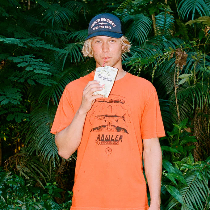 
                      
                        Man outside wearing the Howler Bros Astral Order Cotton T-Shirt in the color Orange
                      
                    