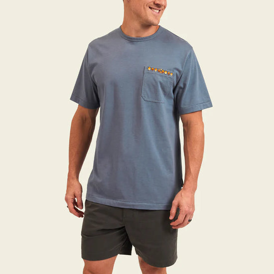 The Howler Bros Spectrum Pocket T in the color Mirage Blue